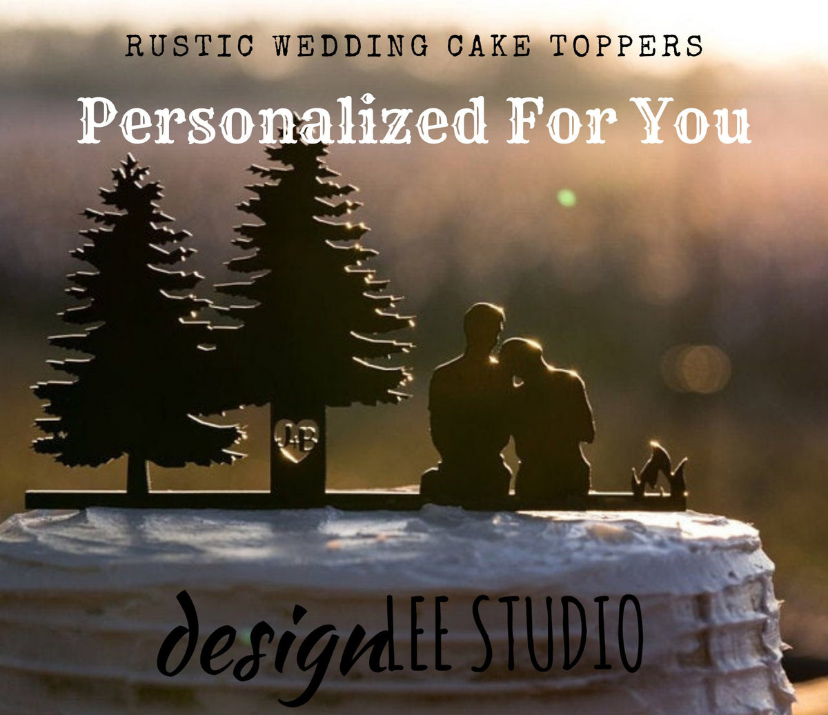 Rustic Wedding Cake Topper and Wedding Decor. Man + Woman Sitting Near Campfire and 2 Trees with the the couples initials cut/carved into the trees. Can be personalized and customized with pets and Mountain Ranges.